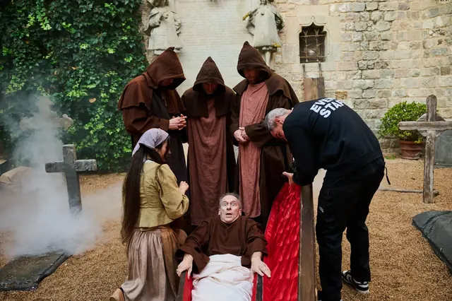 Hooded actors in The Alchemist immersive experience