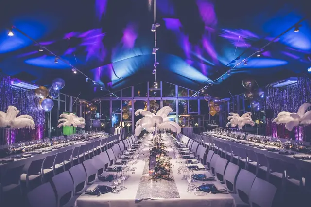 Dinner hall in purple light at Letgo's Studio 54 party