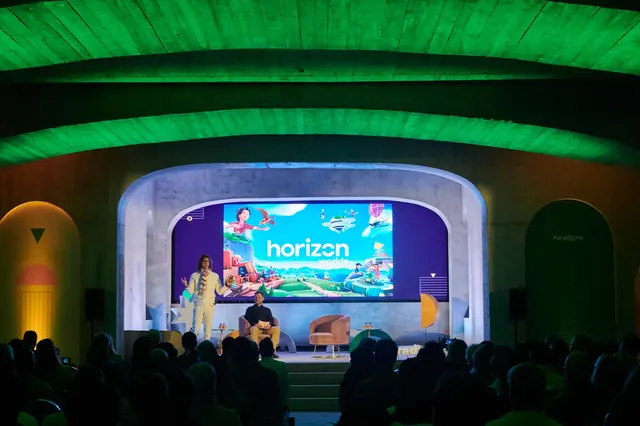 Paradigms conference plenary under green-lit arches